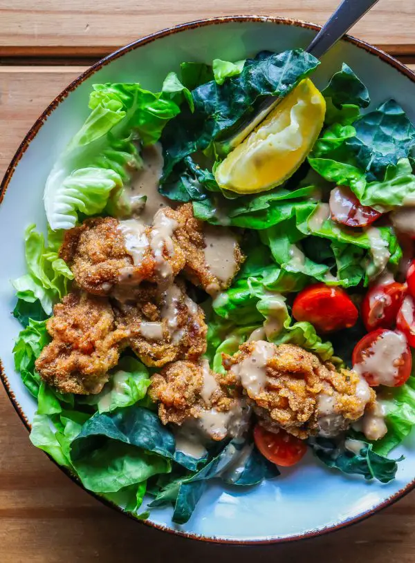 fried oysters over a butter lettuce and tuscan kale salad
