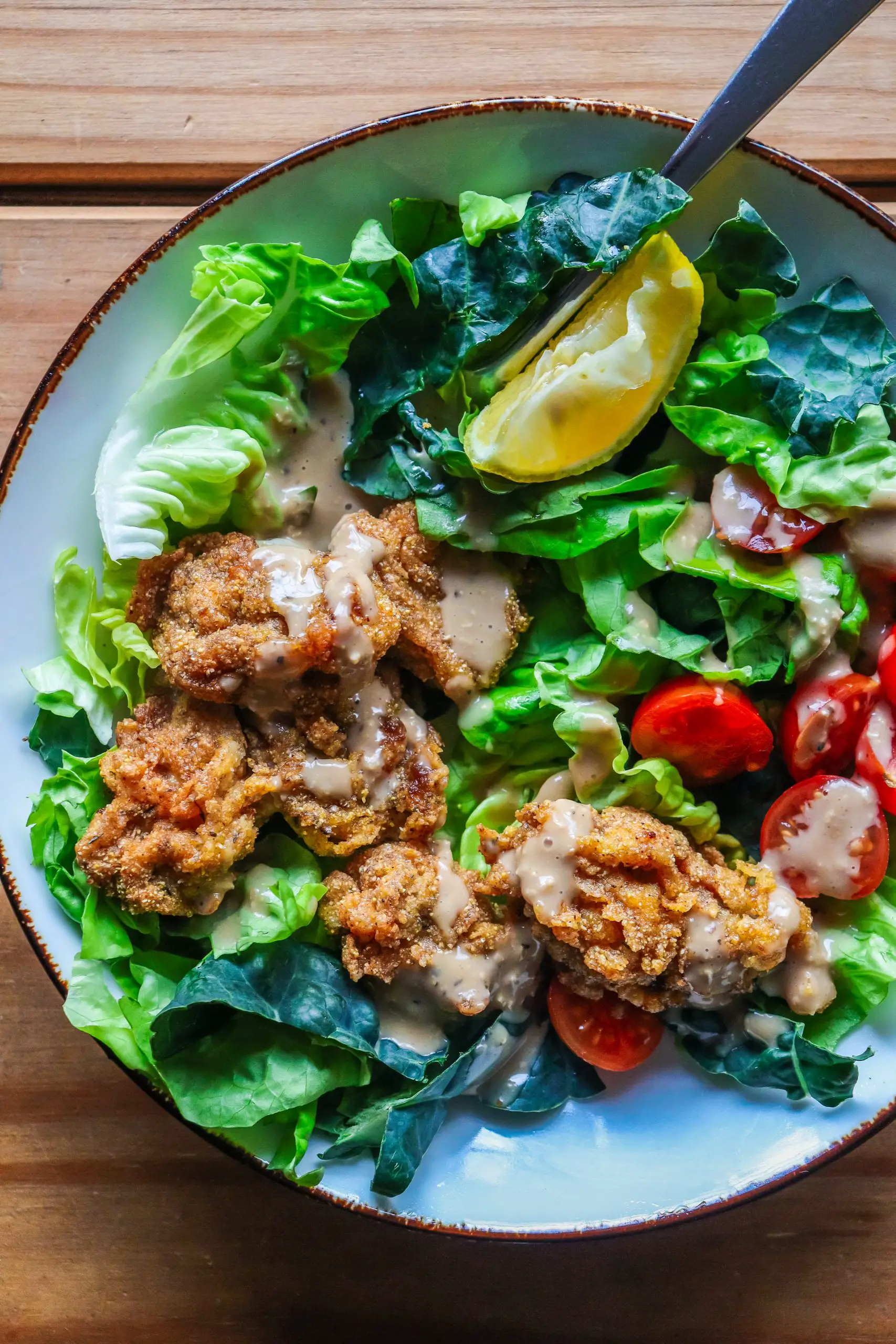 fried oysters over a butter lettuce and tuscan kale salad on www.thedanareneeway.com